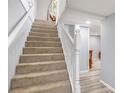 Carpeted staircase with white banister leading to the upper level of the home at 2162 Doris Dr, Decatur, GA 30034