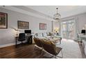 Bright living room with hardwood floors, modern furniture, and a balcony view at 325 E Paces Ferry Ne Rd # 312, Atlanta, GA 30305