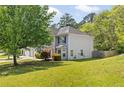 View of home, featuring manicured lawn and mature trees at 3571 Oakshire Se Way, Atlanta, GA 30354