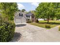 Two story home with two car garage, well manicured lawn and mature trees at 3571 Oakshire Se Way, Atlanta, GA 30354