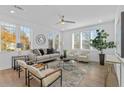 Bright living room with a ceiling fan, neutral-toned furniture, large windows, and contemporary decor at 392 Pratt Dr # 2013, Atlanta, GA 30315