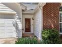 A close-up view of the house number, white siding, and a red brick wall by the front door at 4805 Diggers Way, Sugar Hill, GA 30518