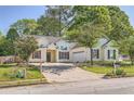 Traditional one-story home with attached garage and driveway and manicured front lawn with trees at 772 Bostonian Way, Lawrenceville, GA 30046