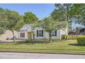 Well-maintained one-story home featuring a tidy front lawn, mature trees, and dark shutter accents at 772 Bostonian Way, Lawrenceville, GA 30046