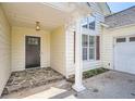 The front entrance has stone flooring and classic column, next to attached garage door at 772 Bostonian Way, Lawrenceville, GA 30046
