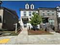 Well-maintained brick and painted brick townhome with mature landscaping at 1329 Bennett Creek Ovlk, Suwanee, GA 30024