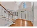 Bright foyer featuring hardwood floors, white trim, and transom window above the front door at 1548 Valley Reserve Nw Ct, Kennesaw, GA 30152