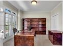 Well-lit office with custom built-in bookshelves and sleek contemporary desk at 1548 Valley Reserve Nw Ct, Kennesaw, GA 30152