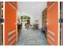 View through the front doorway showcasing an open floor plan with stone accent wall and tile flooring at 2895 Dunnington Cir, Atlanta, GA 30341