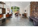 An open living room featuring a stone accent wall and large windows offering beautiful outdoor views at 2895 Dunnington Cir, Atlanta, GA 30341