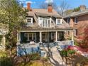 Lovely two-story home featuring a spacious front porch, dormer windows, and mature trees in a desirable neighborhood at 462 N Highland Ave, Atlanta, GA 30307
