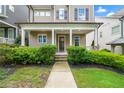 Inviting front porch with classic columns and lush landscaping, enhancing curb appeal at 52 Lath House Ln, Marietta, GA 30066