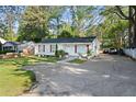 Inviting single-story home with neat front yard, classic white exterior, and convenient driveway at 5573 Singleton Rd, Norcross, GA 30093