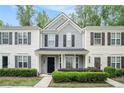 Inviting townhome with neutral siding, black shutters, and manicured landscaping, enhancing curb appeal at 1728 Devon Sw Dr, Atlanta, GA 30311