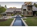 Stunning rear exterior showcasing a modern pool, lush lawn, and elegant architecture at 2979 Ridgewood Nw Rd, Atlanta, GA 30327