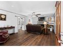 Comfortable living room featuring wood floors, a fireplace, and a view into the kitchen at 363 Arnold Mill Rd, Woodstock, GA 30188