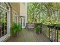 Outdoor deck area featuring comfortable seating, lush greenery, and picturesque views of the surrounding trees at 4470 Crestwicke Pointe, Atlanta, GA 30319