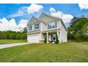 Two-story home with a large, grassy front yard and attached two-car garage at 74 Macland Mill Ln, Dallas, GA 30157