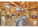 Spacious living room with a stone fireplace, vaulted ceilings, wood beams, and tile flooring at 800 Knox Ln, Canton, GA 30114