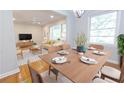 Dining area view showcasing table set, natural light and openness to the adjacent living room at 145 Holly Nw Rd, Atlanta, GA 30314