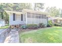 Charming home with a well-maintained lawn, a screened-in porch, and stone walkway at 145 Holly Nw Rd, Atlanta, GA 30314