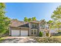 Lovely two-story brick home with two-car garage framed by mature trees, offering curb appeal at 2130 Boulder Gate Dr, Ellenwood, GA 30294