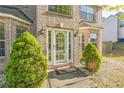 Close up of the entry to a brick home showing a well kept lawn and manicured greenery at 2130 Boulder Gate Dr, Ellenwood, GA 30294