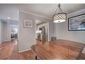 Dining room featuring an overhanging light fixture, hardwood floors, and view to kitchen and bedroom at 505 Bainbridge Dr, Atlanta, GA 30327