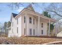Elegant two-story home with white siding, a covered porch, and stately columns at 119 E Johnson St, Temple, GA 30179