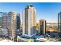 Exterior of luxurious high-rise condo building with blue sky view, a tennis court, and a swimming pool at 1280 W Peachtree Nw St # 2201, Atlanta, GA 30309