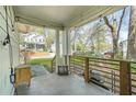 View of the front porch with wooden railings, string lights, and seating area at 240 Lamon Se Ave, Atlanta, GA 30316
