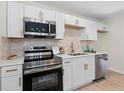 Modern kitchen with stainless steel appliances, white cabinetry, and quartz countertops at 3326 Northcrest Rd # C, Atlanta, GA 30340