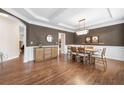 Refined dining area showcases sleek floors, wainscoting details, and elegant table setting at 1299 Dunwoody Cv, Atlanta, GA 30338