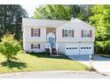 Well-maintained home with a two-car garage, manicured lawn, and inviting curb appeal at 140 Maplewood Dr, Temple, GA 30179
