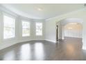 Spacious living room with hardwood floors, large windows, and elegant trim at 1821 Silver Crest Way, Hoschton, GA 30548