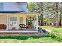 Relaxing covered patio with ceiling fans offering a view of the landscaped yard at 377 Lakeview Dr, Newborn, GA 30056
