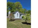 Home exterior featuring a side entry garage and a well-maintained lawn with mature trees at 760 Whitehall Way, Roswell, GA 30076