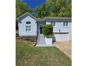 Charming home featuring well-maintained lawn, inviting entry, and convenient two-car garage at 760 Whitehall Way, Roswell, GA 30076