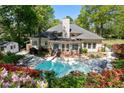 Enjoy outdoor living in this private backyard with a sparkling pool and lounge area at 12260 Greenmont Walk, Alpharetta, GA 30009