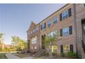 Charming brick townhome with classic black shutters and landscaped yard at 3877 Via Cima Ln, Suwanee, GA 30024