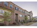 Row of brick townhomes with inviting entrances and manicured landscaping at 3877 Via Cima Ln, Suwanee, GA 30024