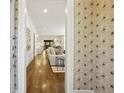 Inviting hallway view into the living room, featuring hardwood floors and stylish wallpaper at 391 Collier Nw Rd, Atlanta, GA 30309