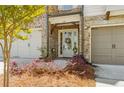 Inviting home entrance with brick accents, a decorative wreath, and a well-manicured garden at 605 Stone Field Nw Run, Marietta, GA 30060