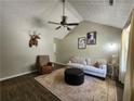 Cozy living room with vaulted ceilings, neutral tones, wood floors, and a ceiling fan at 7235 Hummingbird Ln, Winston, GA 30187