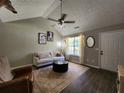 Inviting living room with vaulted ceilings, dark wood floors, stylish decor, and natural light at 7235 Hummingbird Ln, Winston, GA 30187