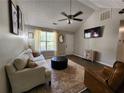 Bright living room with dark wood floors, neutral decor, vaulted ceilings, and comfortable seating at 7235 Hummingbird Ln, Winston, GA 30187