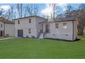 Lovely two-story house with a modern design, green lawn, and a welcoming front entrance at 9148 Homewood Dr, Riverdale, GA 30274