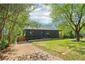 Quaint home with a charming front porch, surrounded by trees, and ample driveway space at 1596 Pontiac Se Pl, Atlanta, GA 30315