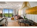 Open-concept living and dining area with modern lighting, a marble table, and expansive balcony access at 2233 Peachtree Ne Rd # 1207, Atlanta, GA 30309