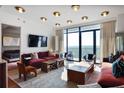 Bright living room boasts a large window with balcony and modern interior design at 2233 Peachtree Ne Rd # 1207, Atlanta, GA 30309